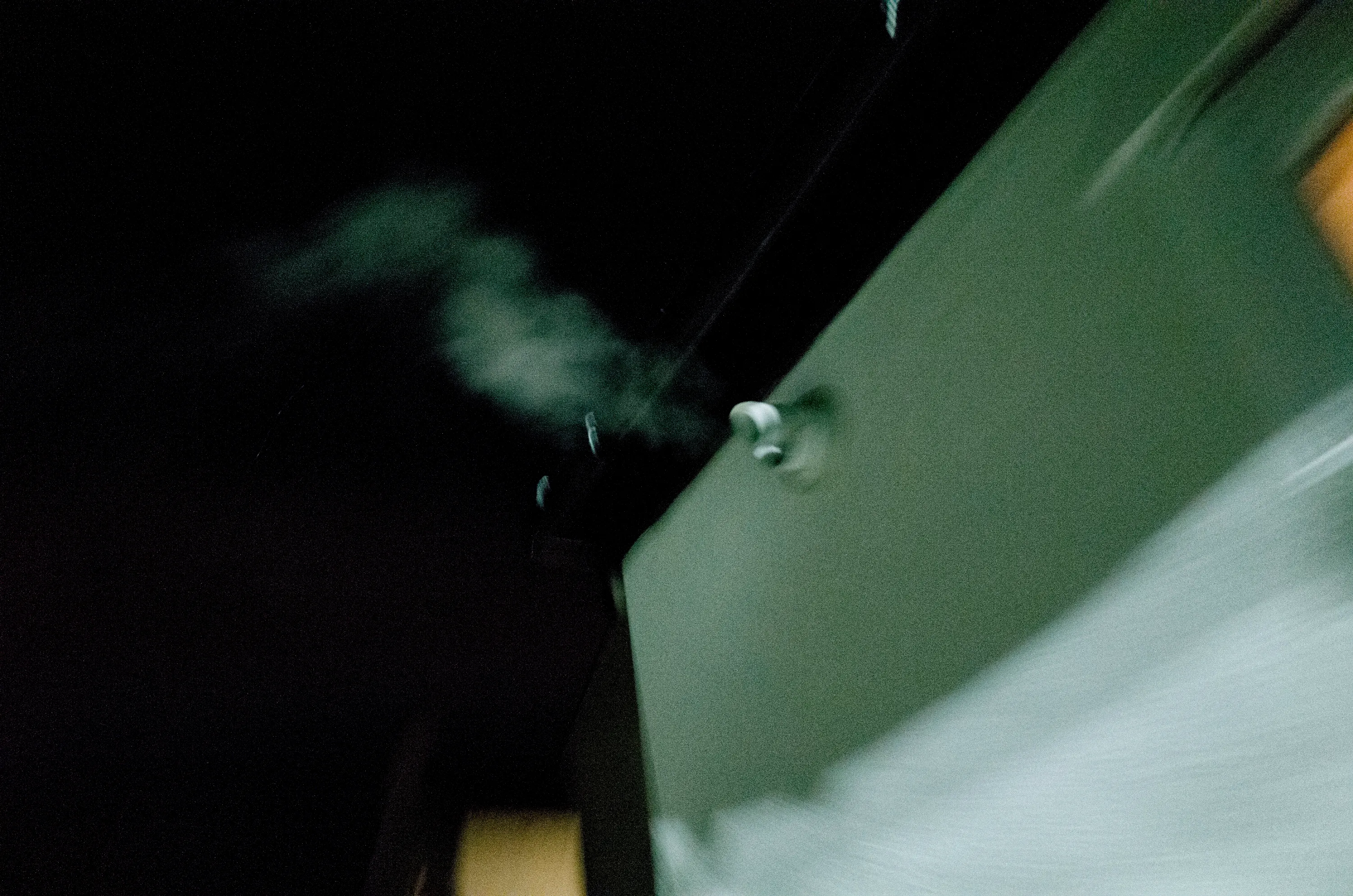 Smoke rising from a building rooftop at night